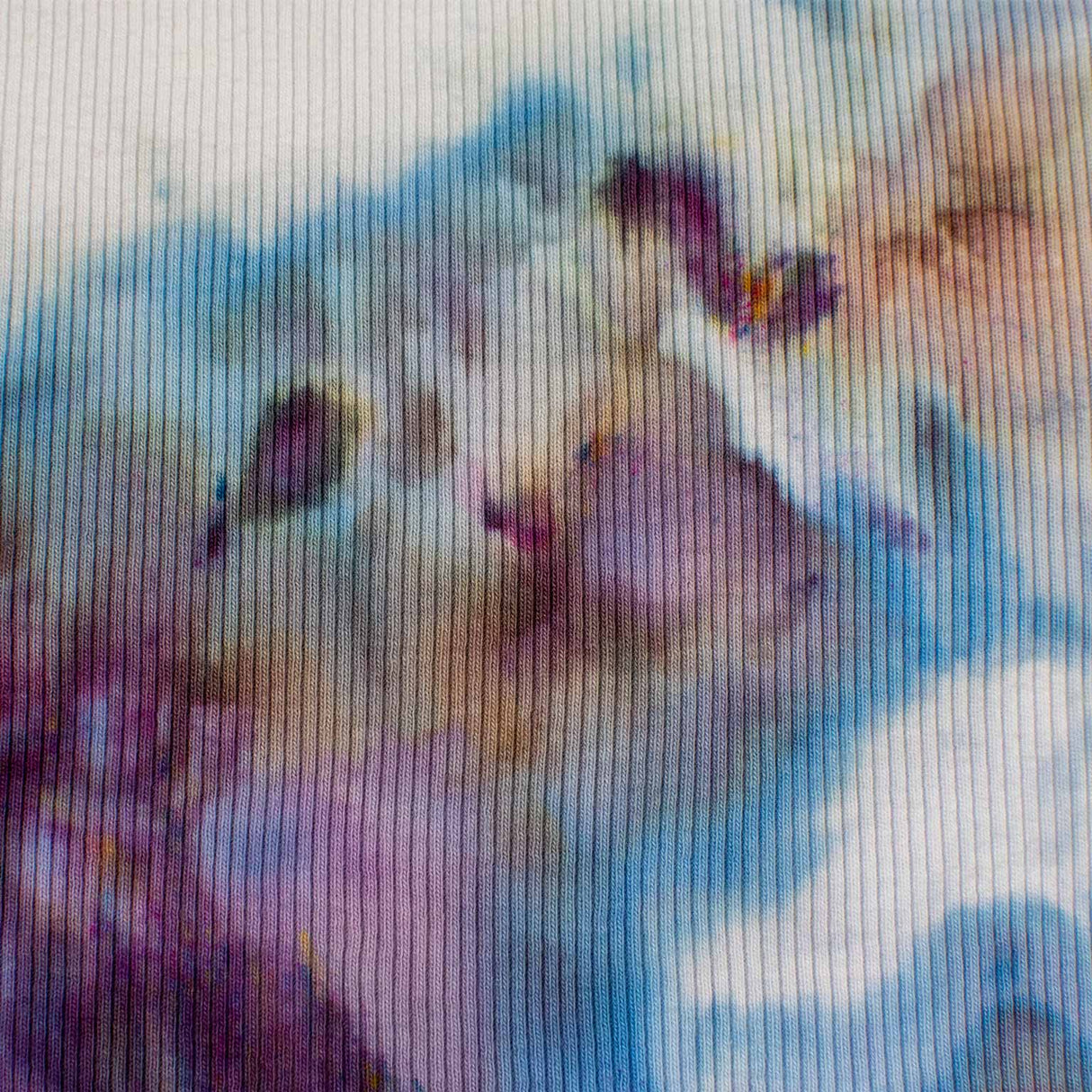 A women's high-neck cropped tank top featuring a soft ice dye pattern with swirls of blue, purple, and white on a white background, creating a dreamy, cloud-like effect.