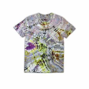 An artisanal ice-dyed t-shirt, its surface a canvas of swirling blues, purples, and chartreuse resembling geode formations, with the text 'dazed' in a stylized, icy lettering at the center.