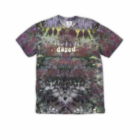 An eye-catching ice-dyed t-shirt showcasing a vibrant explosion of purples, pinks, and grays with a smoky effect around the 'dazed' text featured in the center.