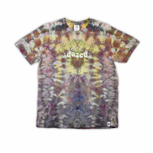 An eye-catching ice-dyed t-shirt showcasing a vibrant explosion of purples, pinks, and grays with a smoky effect around the 'dazed' text featured in the center.