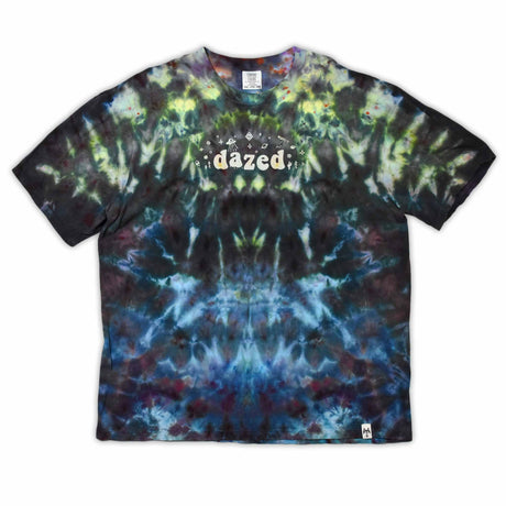 An ice-dyed t-shirt with a mesmerizing array of blues, purples, and subtle greens, reminiscent of a frozen geode, with 'dazed' in an icy font across the chest.