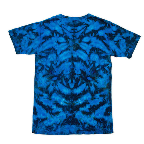 This t-shirt is adorned with a tie-dye design, creating a symmetrical pattern of rich blues that mimic the natural beauty of ocean waves.