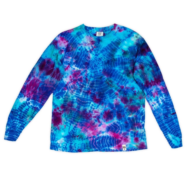 This long sleeve shirt boasts a bold tie-dye pattern with deep blues and bright pinks, reminiscent of a cosmic nebula.