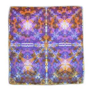 A bandana with a tie-dye design featuring symmetrical bursts of purple, orange, and yellow, creating a mirrored kaleidoscopic effect.