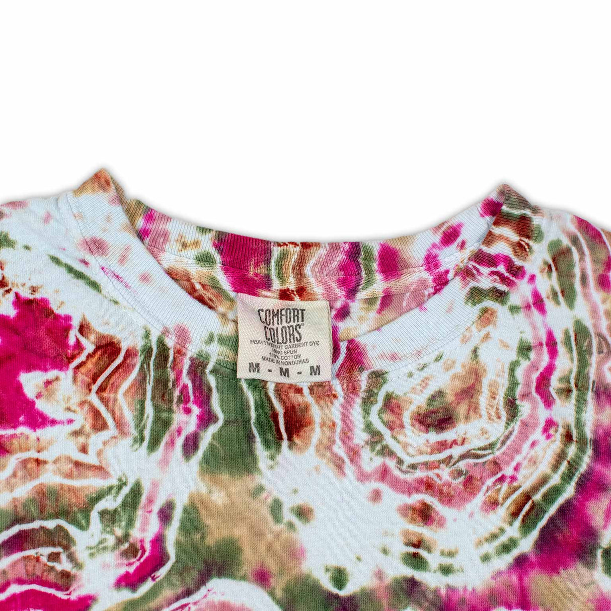 The long sleeve garment features a bold print that resembles cross-sections of gemstones, with rich pinks and greens dominating the design.