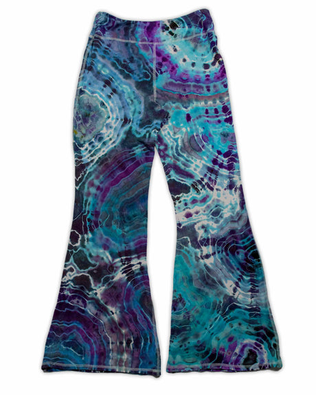 A pair of hand-dyed pants showcasing a unique ice-dye technique with organic patterns in a striking combination of sapphire, violet, and seafoam green.