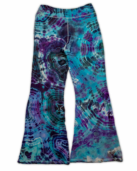 A pair of hand-dyed pants showcasing a unique ice-dye technique with organic patterns in a striking combination of sapphire, violet, and seafoam green.