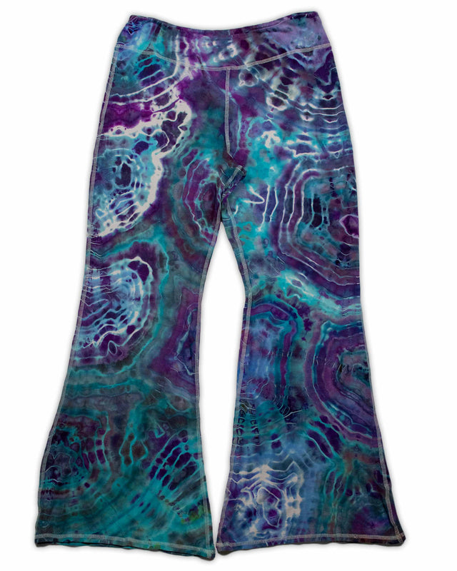 A pair of hand-dyed pants showcasing a unique ice-dye technique with organic patterns in a striking combination of sapphire, violet, and seafoam green.