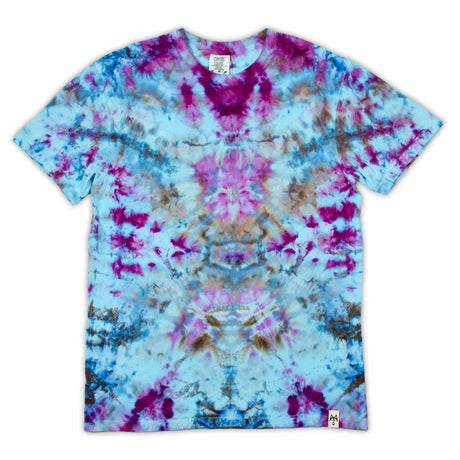 A t-shirt featuring a symmetrical ice dye pattern with a vibrant explosion of sapphire blues and fuchsia pinks against a soft blue background.