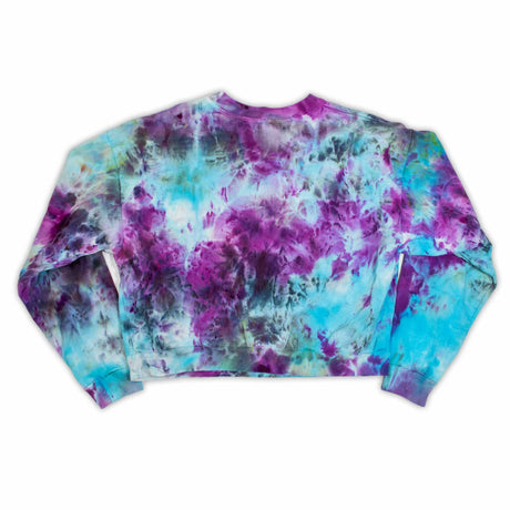 A stylish cropped sweatshirt designed for women, adorned with a cloudy tie-dye pattern in shades of purple and blue.