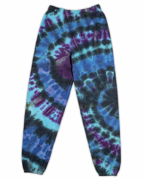 A pair of ice-dyed sweatpants, with a cosmic array of dark blues and purples, reminiscent of a nebula's mysterious beauty.