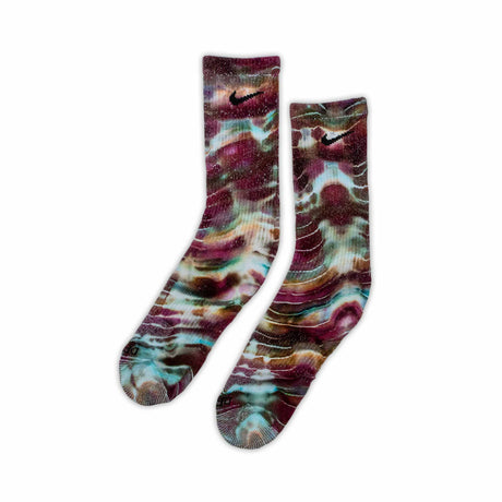 Socks with an artistic ice dye in a cosmic array of dark wine, jade green, and soft beige colors.