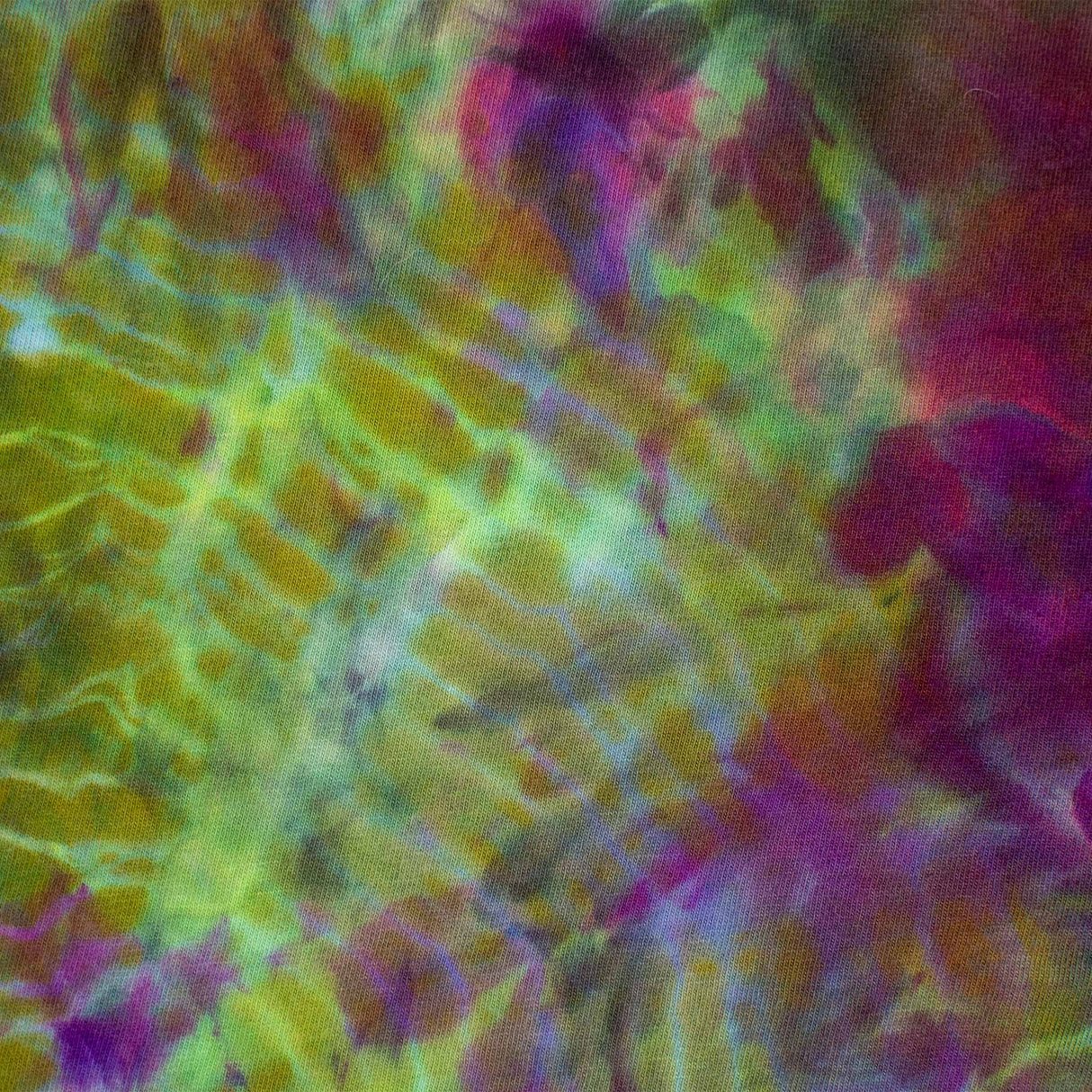A mesmerizing tie-dye long sleeve shirt, with a fusion of emerald green, lavender, and burgundy hues.