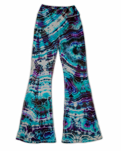 A pair of hand-dyed pants showcasing a unique ice-dye technique with organic patterns in a striking combination of sapphire, violet, and seafoam green.