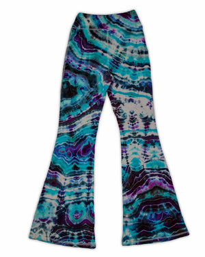 A pair of hand-dyed pants showcasing a unique ice-dye technique with organic patterns in a striking combination of sapphire, violet, and seafoam green.