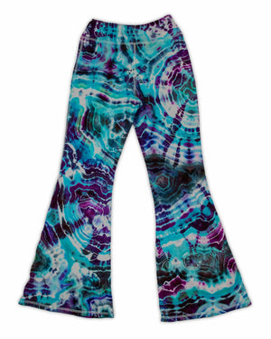 A pair of hand-dyed pants showcasing a unique ice-dye technique with organic patterns in a striking combination of sapphire, violet, and seafoam green.