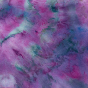 A tie-dye sweatshirt showcases a vibrant pattern of purples and blues, with colors merging fluidly. The ribbed cuffs and hem indicate a cozy and comfortable design.