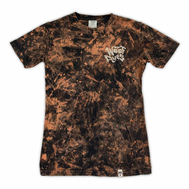 A stylish bleached t-shirt makes a statement with the 'Woof Dyes' logo, amidst a mottled backdrop of blacks and browns for a rugged look.